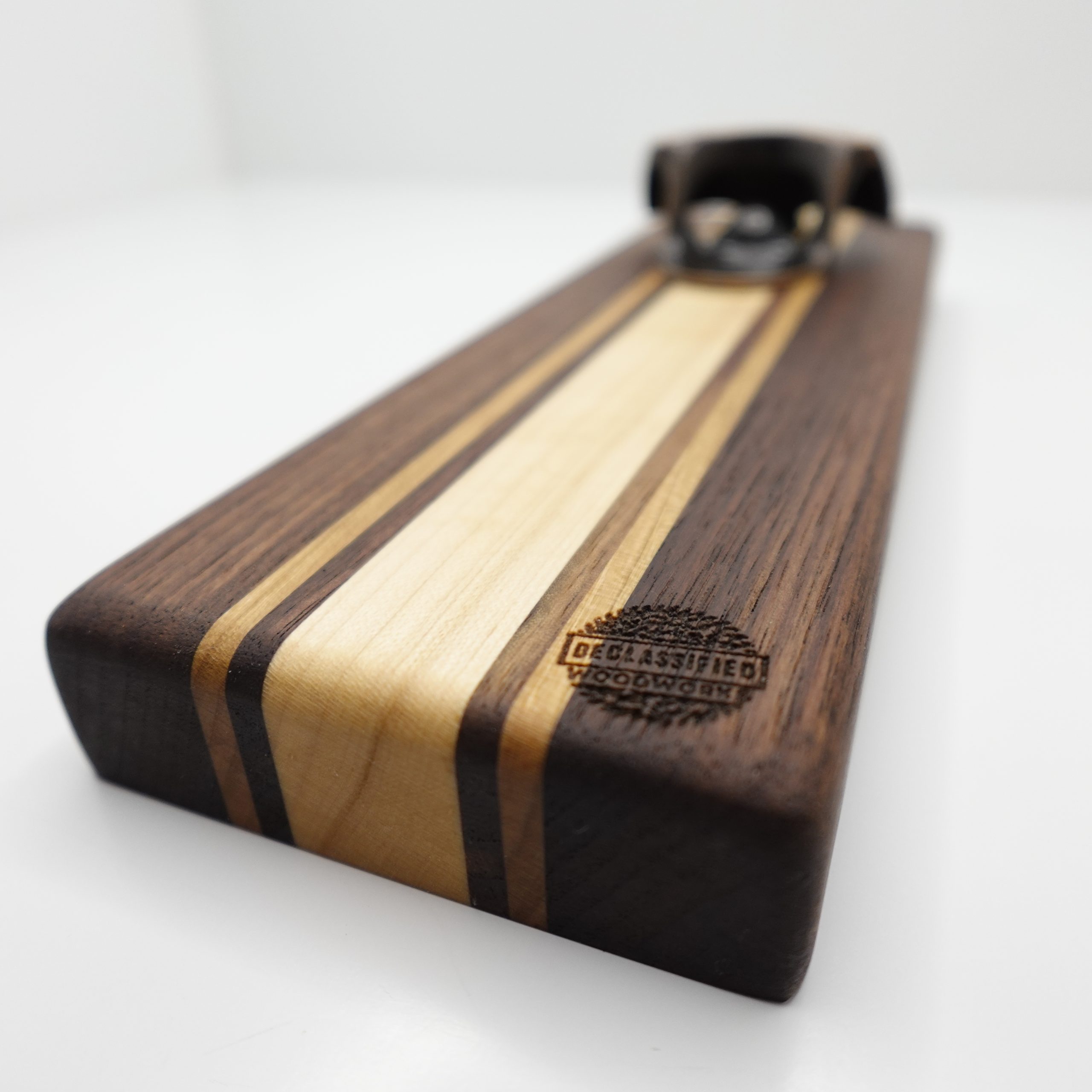 Handmade wall-mounted bottle opener with magnetic cap catcher in walnut, maple, and cherry.